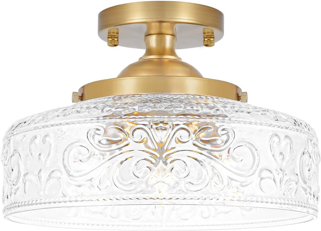 Gold semi-flush ceiling light featuring a clear embossed glass globe shade