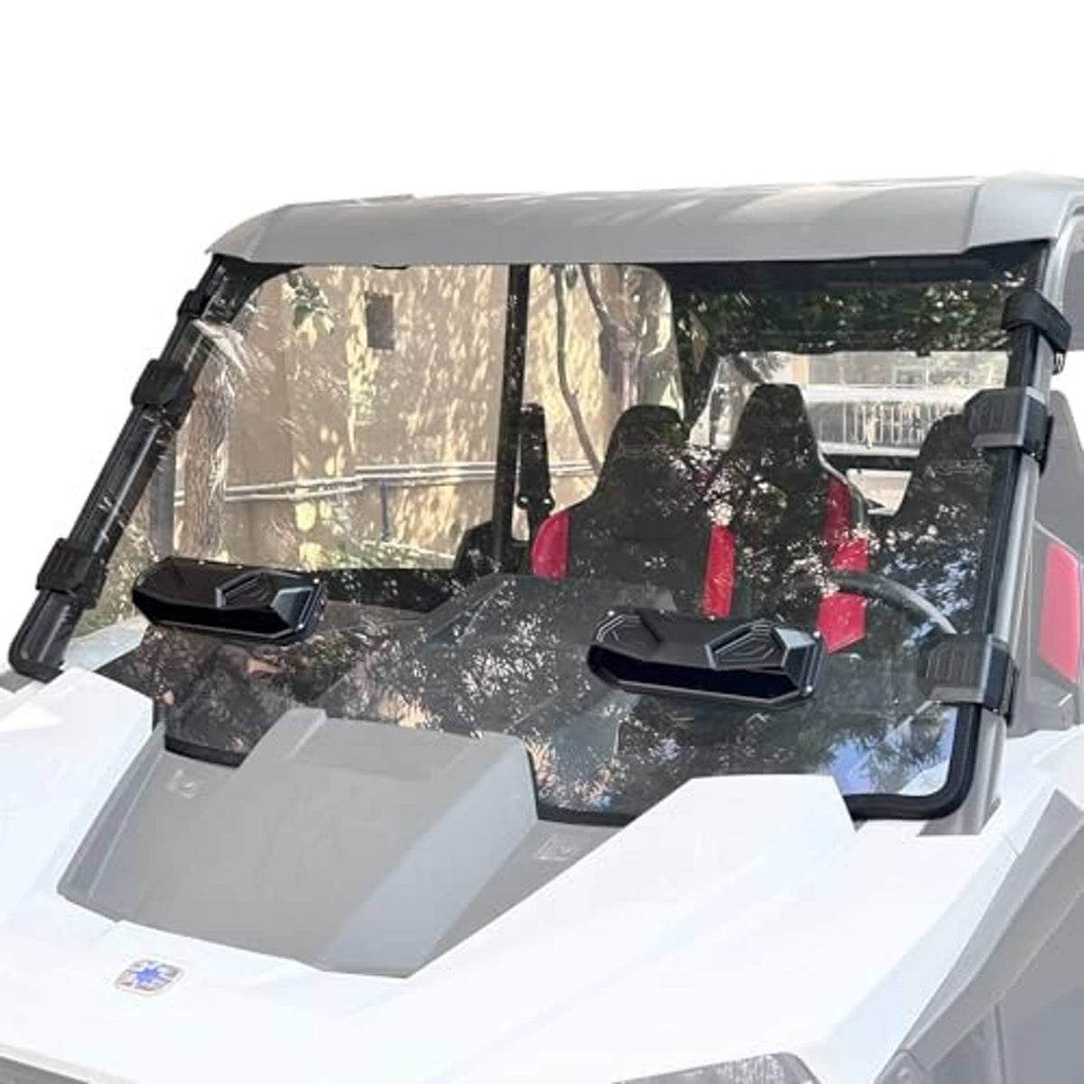 Clear UTV windshield with black hinges and side brackets mounted on front cab.