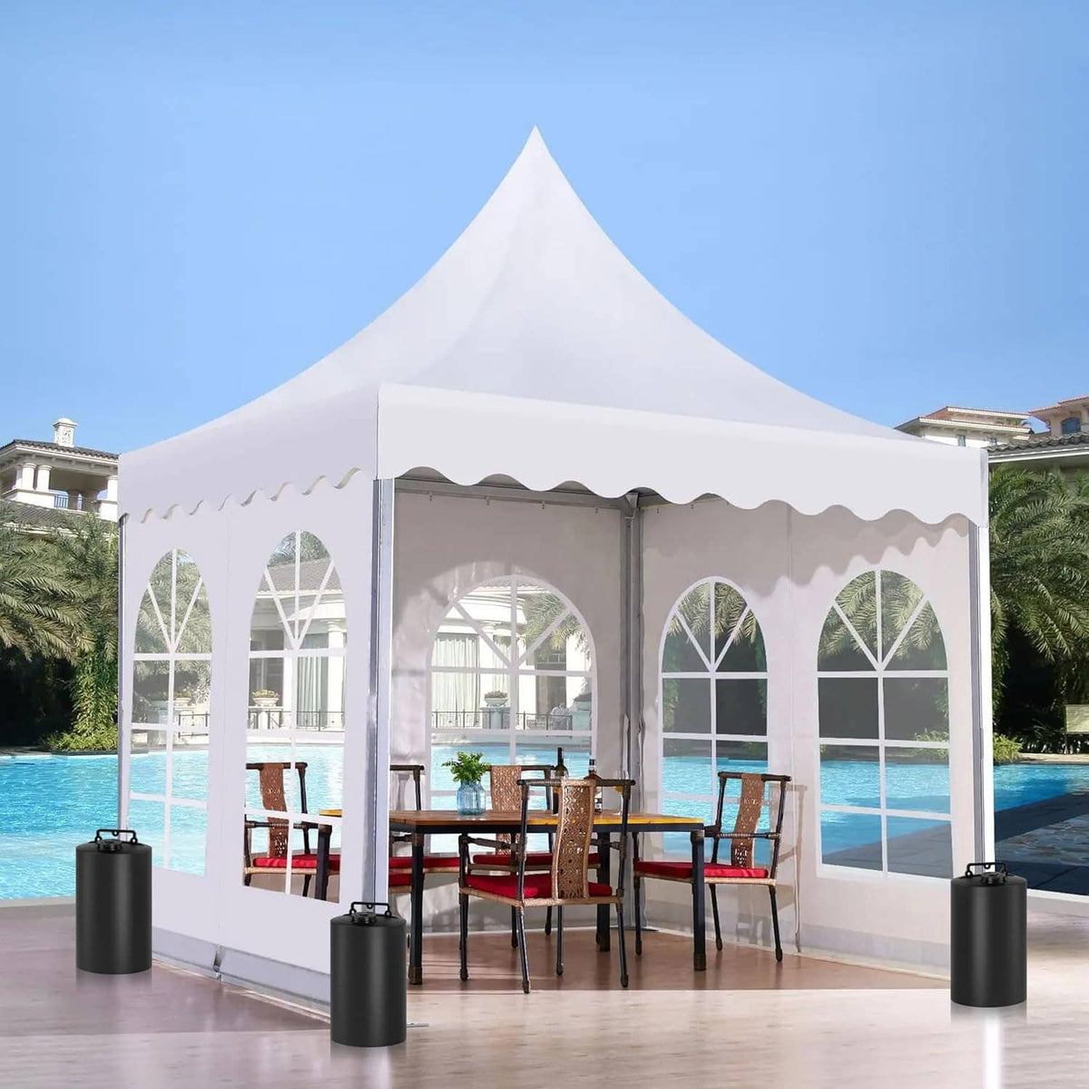 Black water weight bag attached to white canopy poles with side straps near a pool