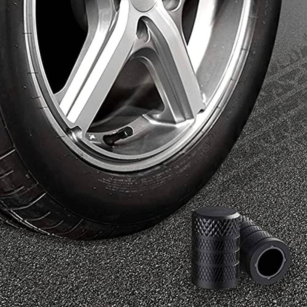 Black textured tire valve stem caps with wide rim and central valve opening