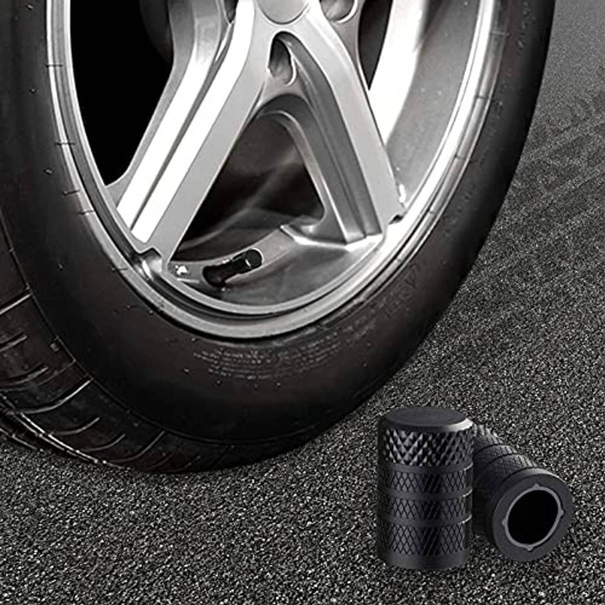Black textured tire valve stem caps with wide rim and central valve opening
