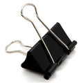Large black binder clip with metal wire handle and latch, single clip on white