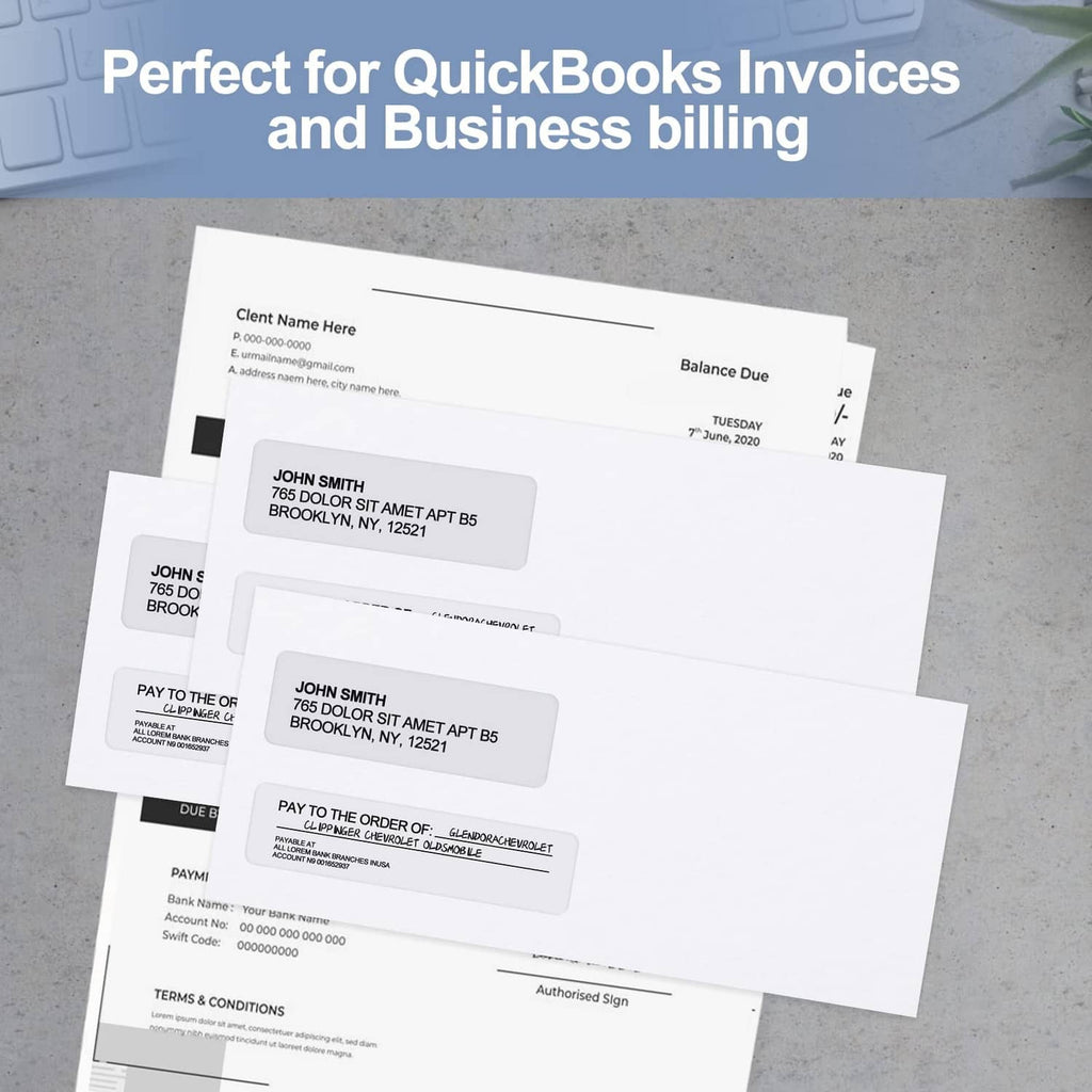 Double-window security envelopes with business documents stacked on gray surface