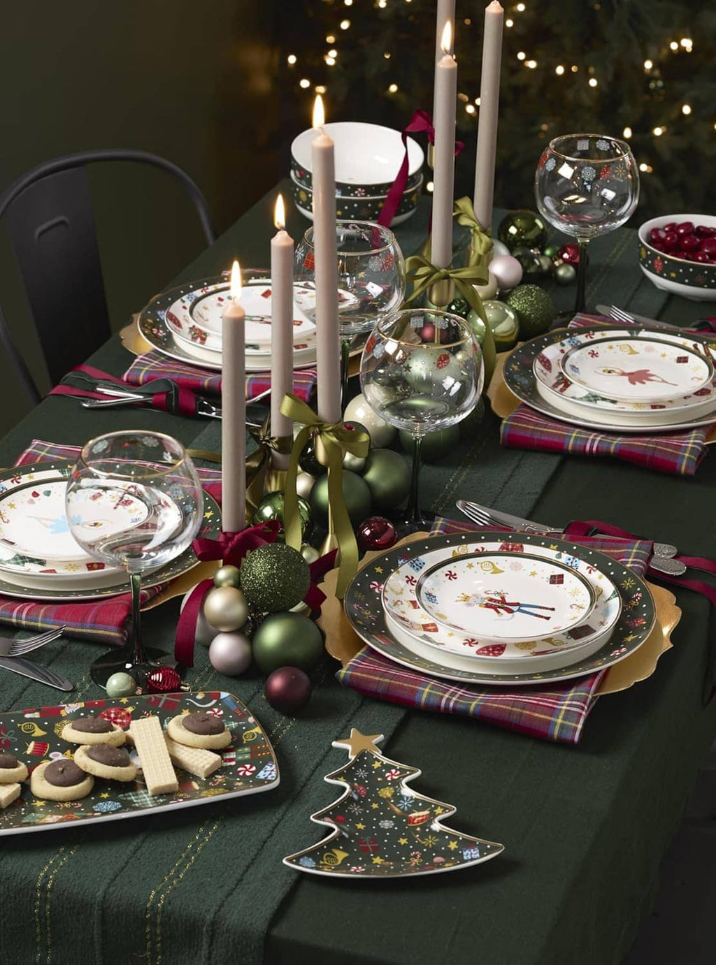 Holiday table setting with multiple porcelain dinner plates, dark borders, and nutcracker motifs