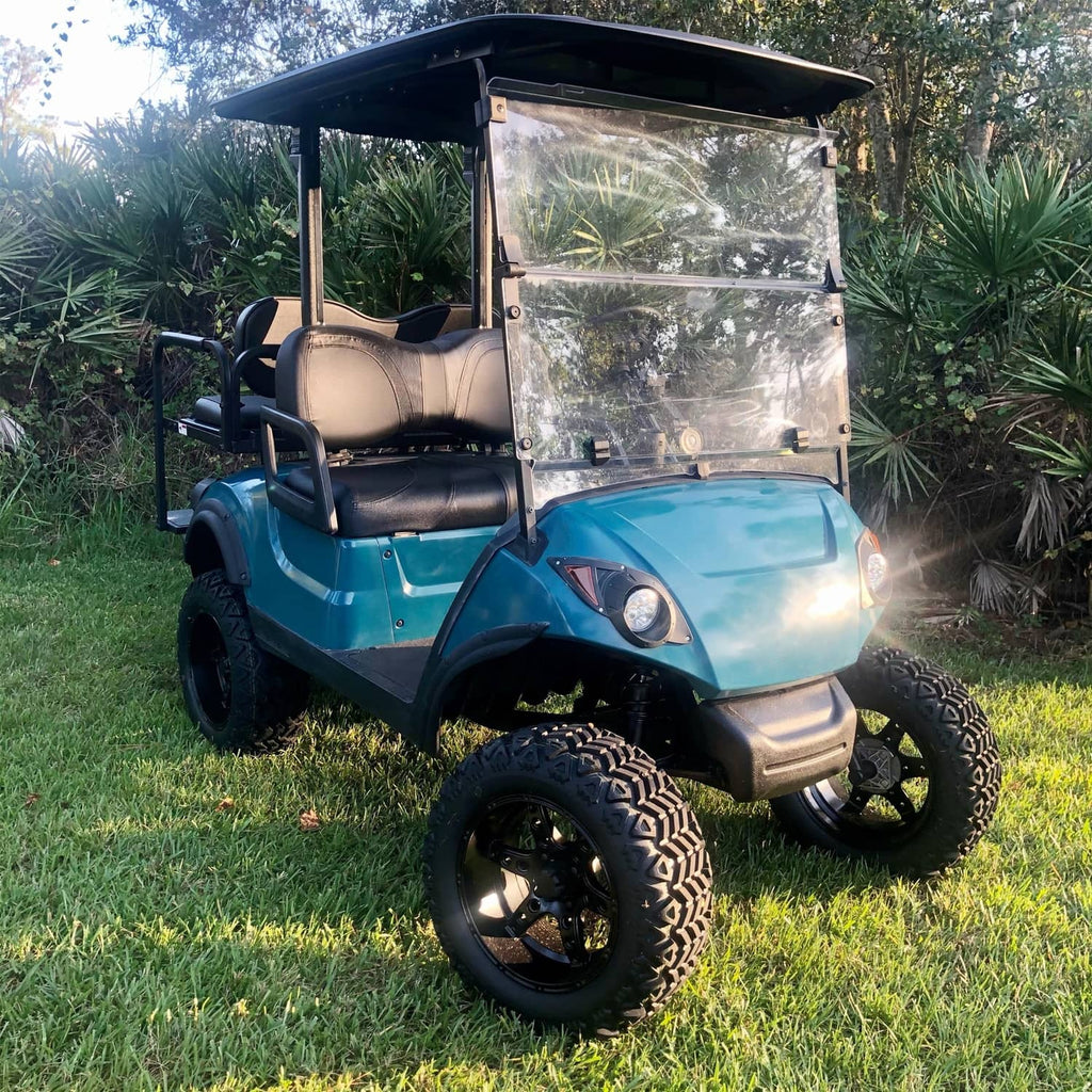 Golf cart fender flares installed on front fender area, black plastic on blue cart