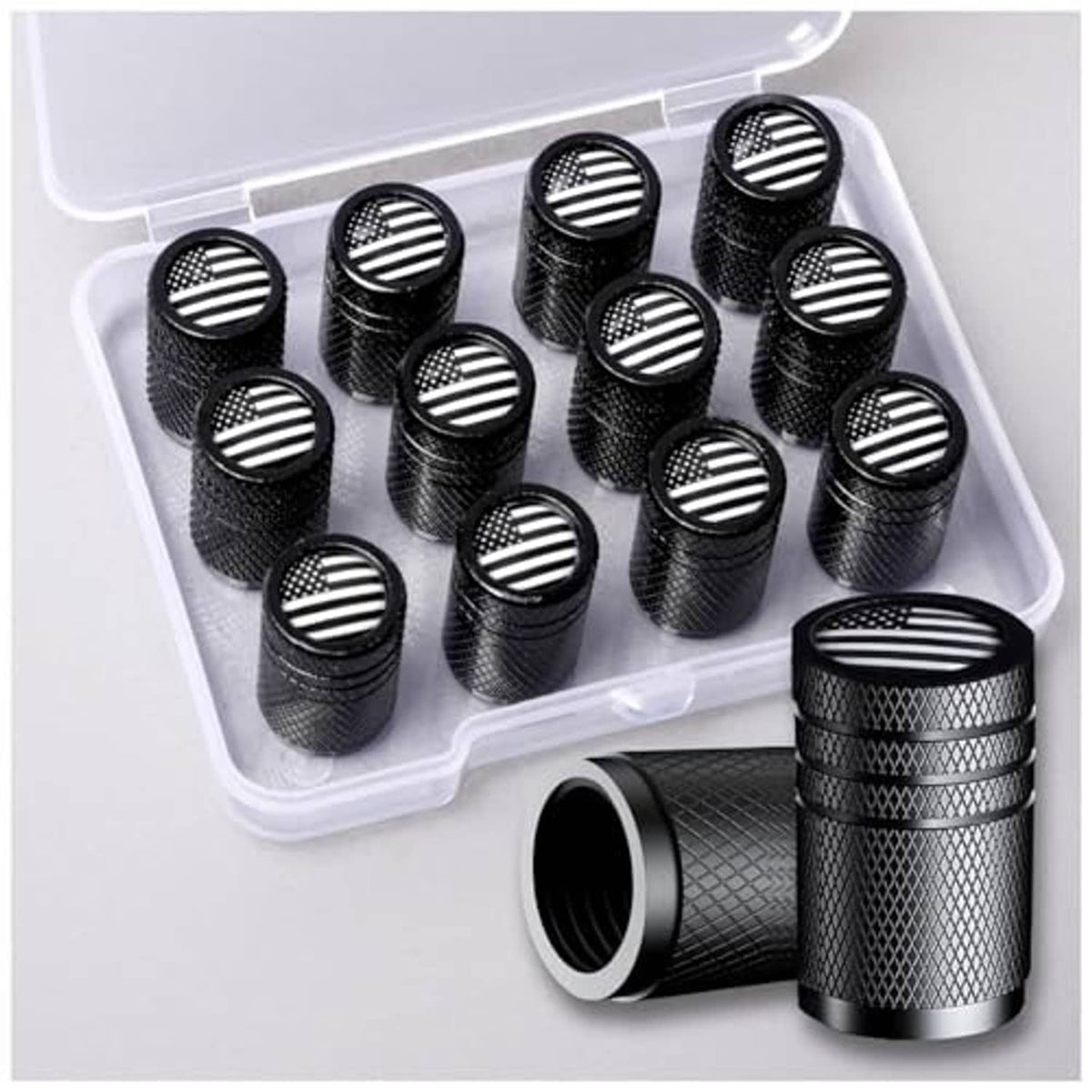 Black aluminum tire valve stem caps with American flag round tops in plastic organizer