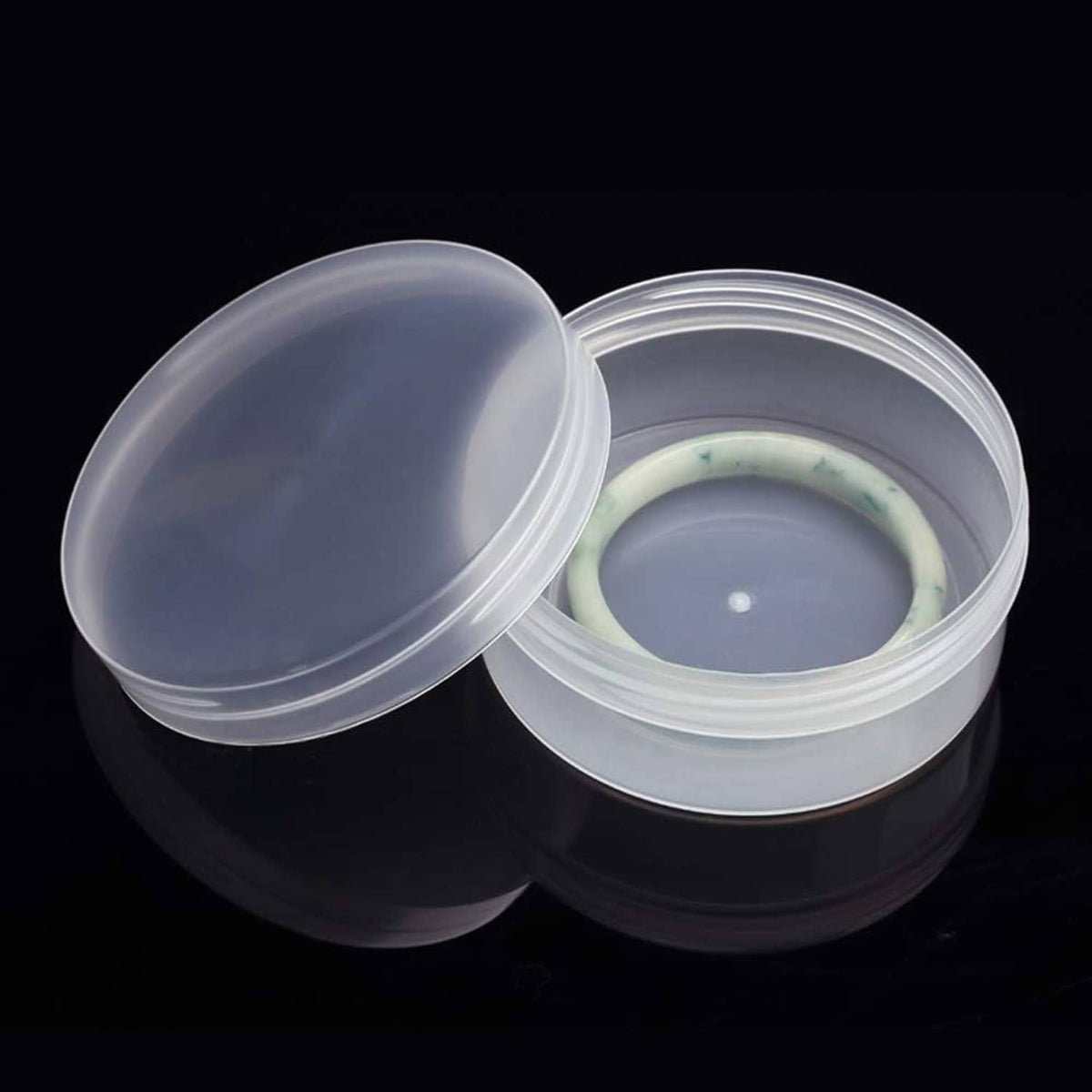 Round clear frosted plastic jar container with open lid and translucent insert