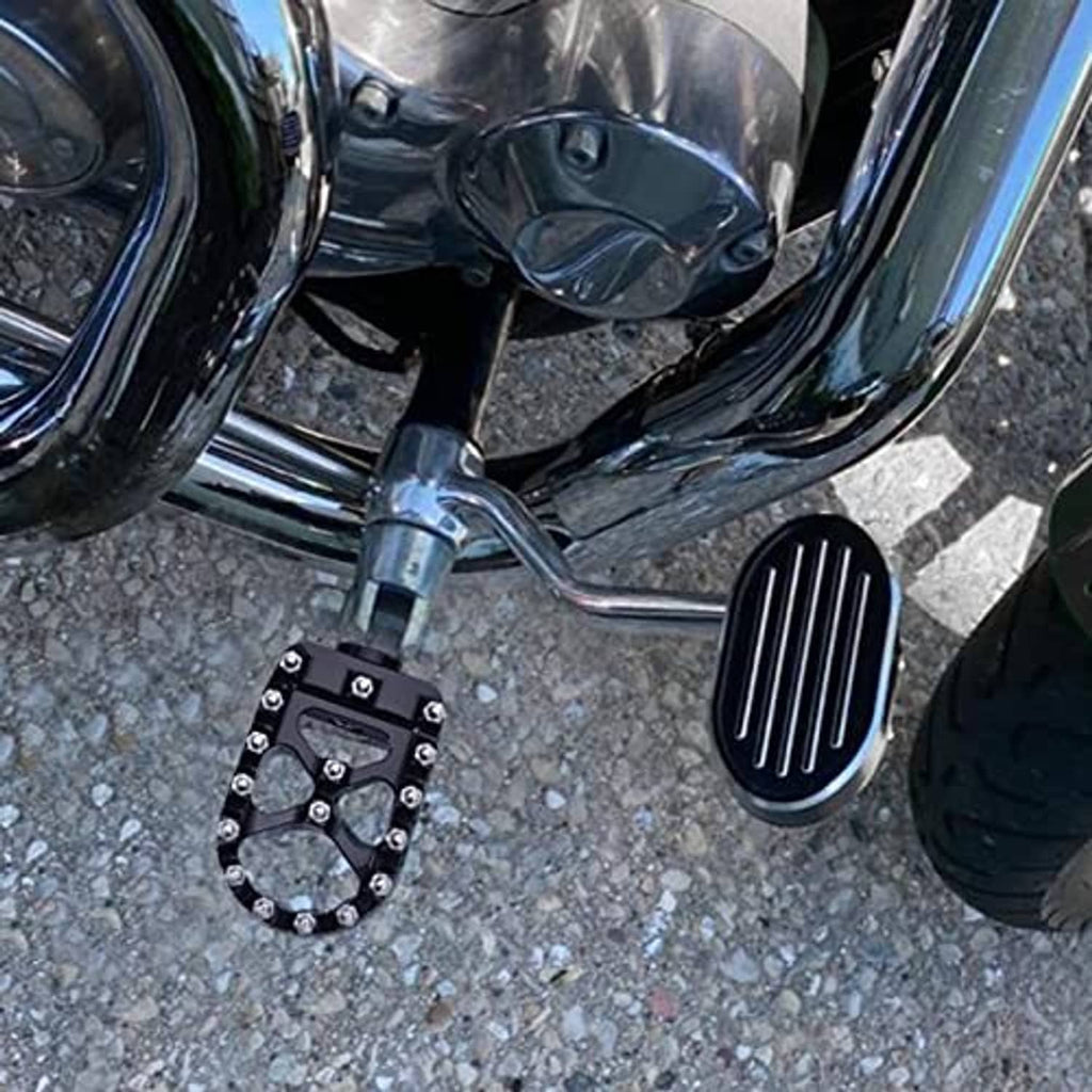 Black grooved brake pedal pad cover mounted on motorcycle foot control area