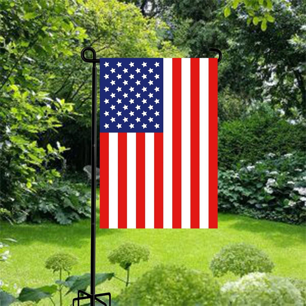 Black garden flag stand pole with five-prong base holding a patriotic flag
