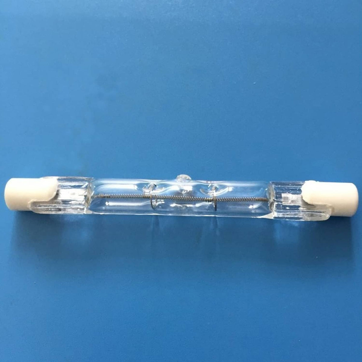 T3 halogen bulb with clear glass tube and two-pin base with white ceramic ends
