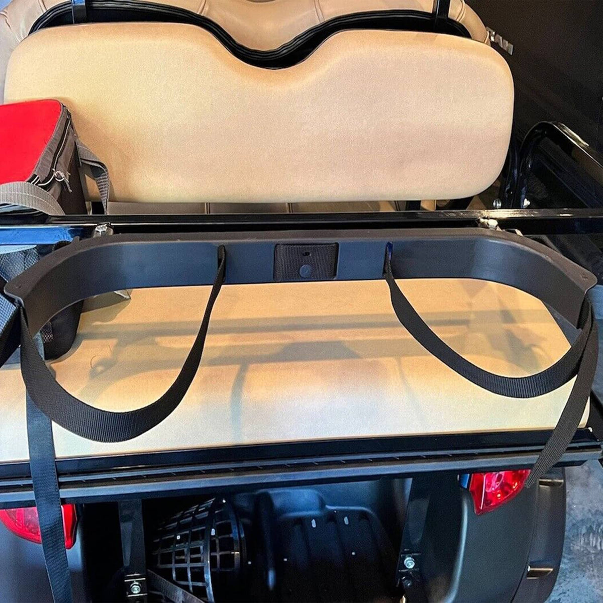 Black golf cart bag holder bracket with two straps attached under rear seat