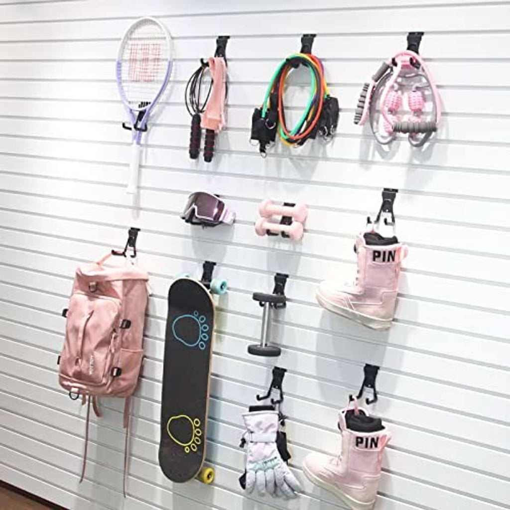 Black slatwall U hooks holding bags and accessories on a wall grid