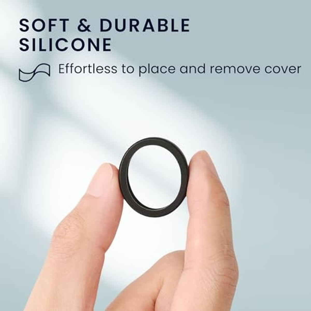 Black silicone smart ring protective cover ring, held between fingers.