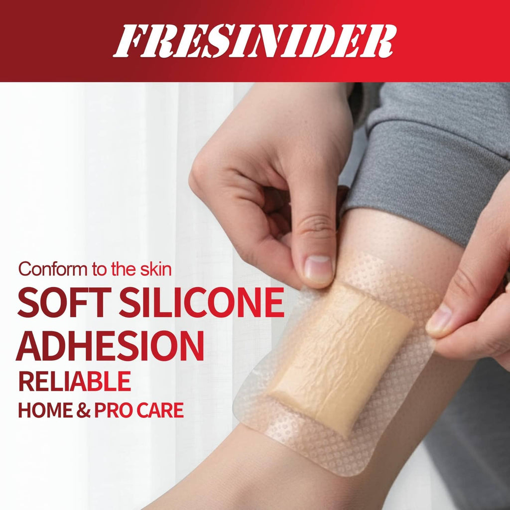 Beige silicone foam dressing pad on forearm skin with soft, conforming adhesion