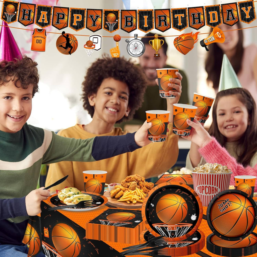 Basketball birthday party table set with orange cups, plates, and black-orange tablecloth
