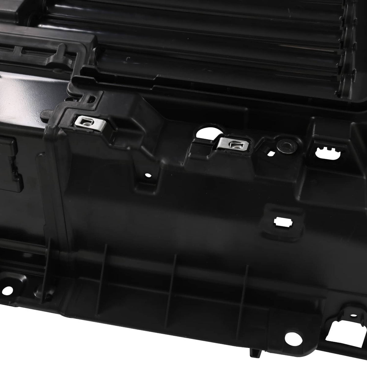 Black grille shutter housing with latch tabs and integrated shutter panel