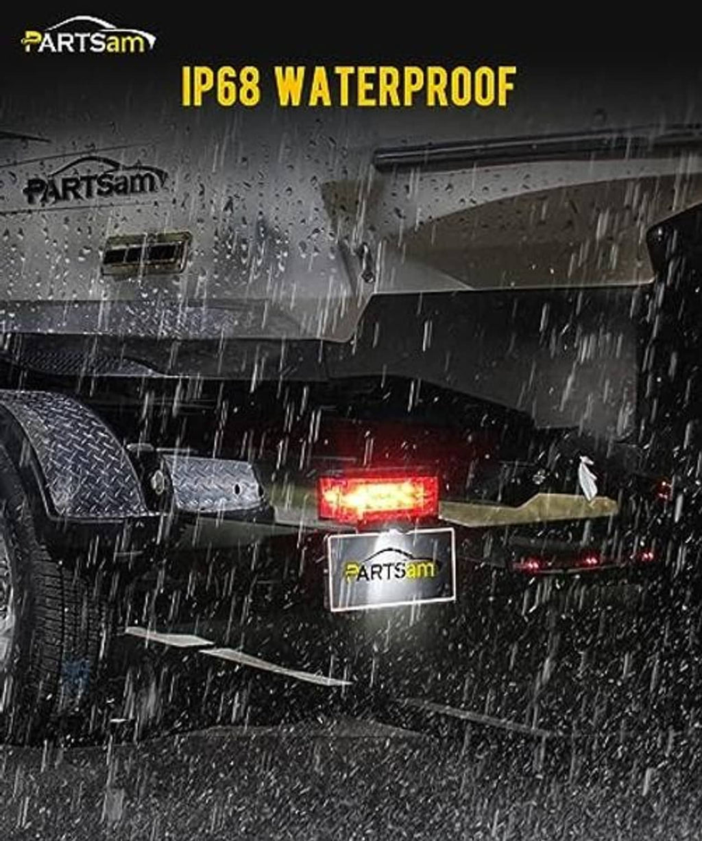 Illuminated red rectangular LED trailer light in wet conditions, black low-profile housing