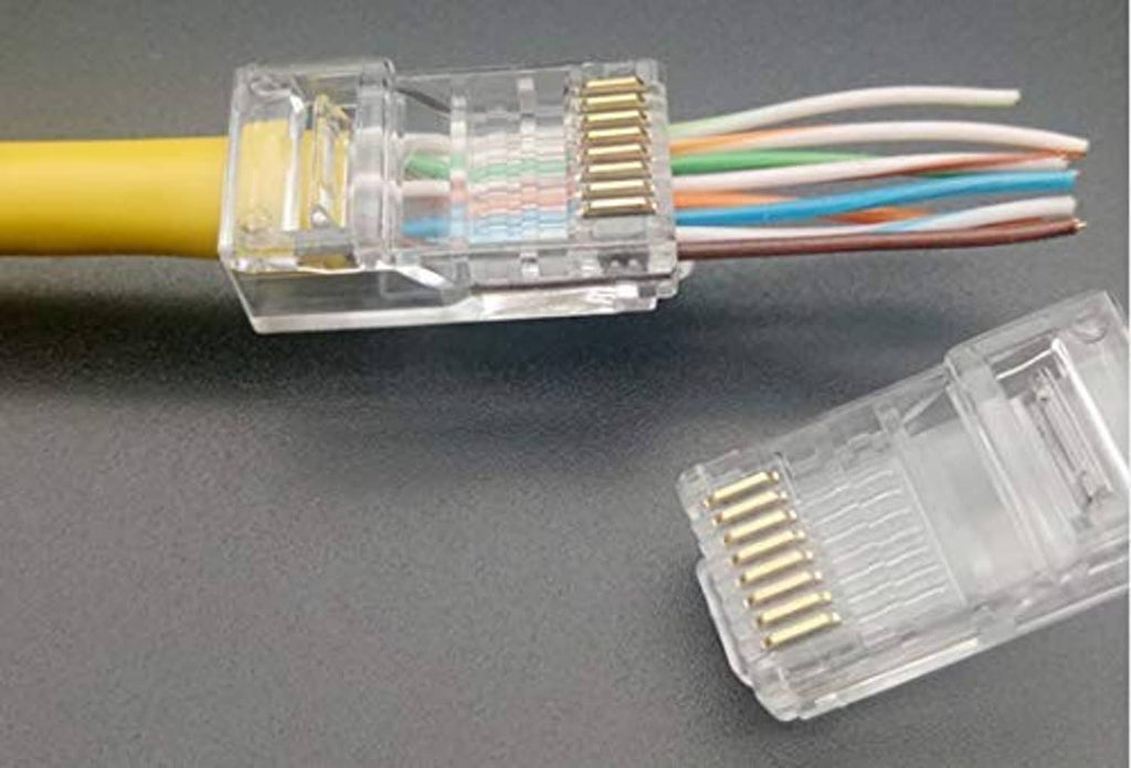RJ45 pass-through connectors on ethernet cables with visible gold pin contacts