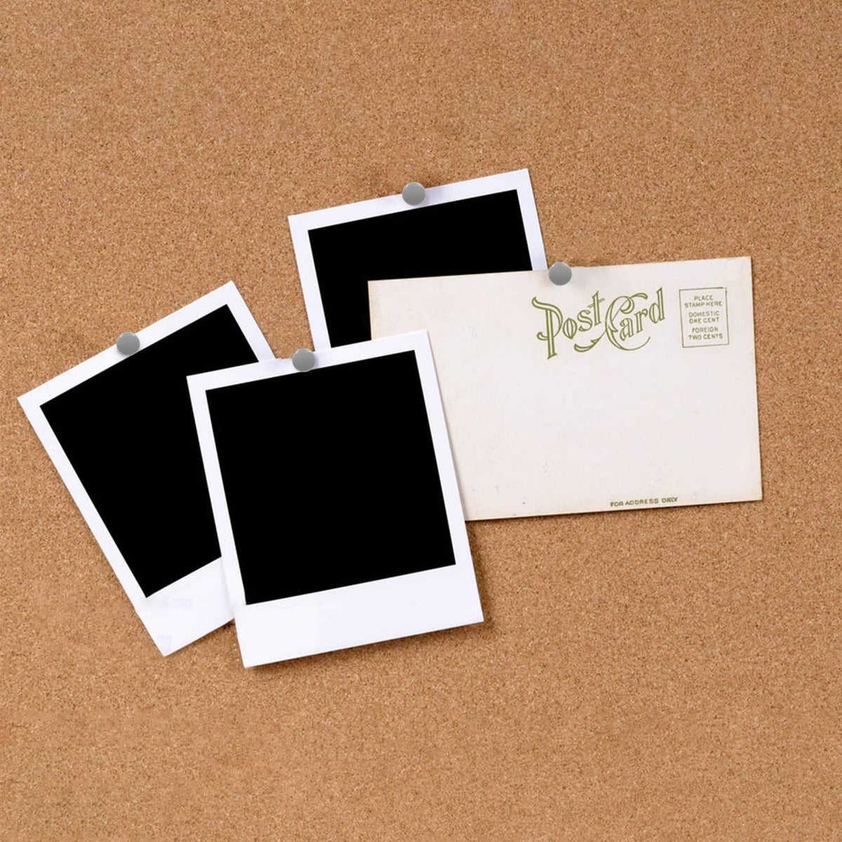 Photo-style cards pinned on a corkboard with gray round-head thumbtacks and gold pins