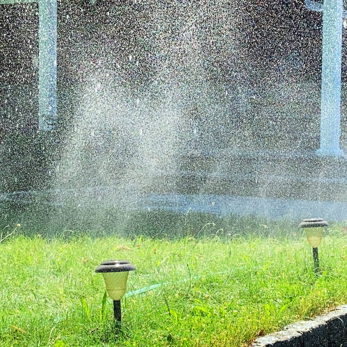 Three-tube sprinkler heads with steady water spray over grass