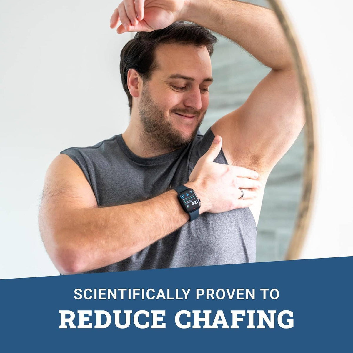 Man applying whole body deodorant stick to underarm with watch on
