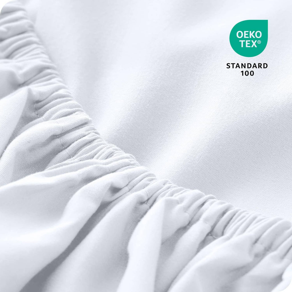 White microfiber fitted sheet close-up with gathered elastic edge detail