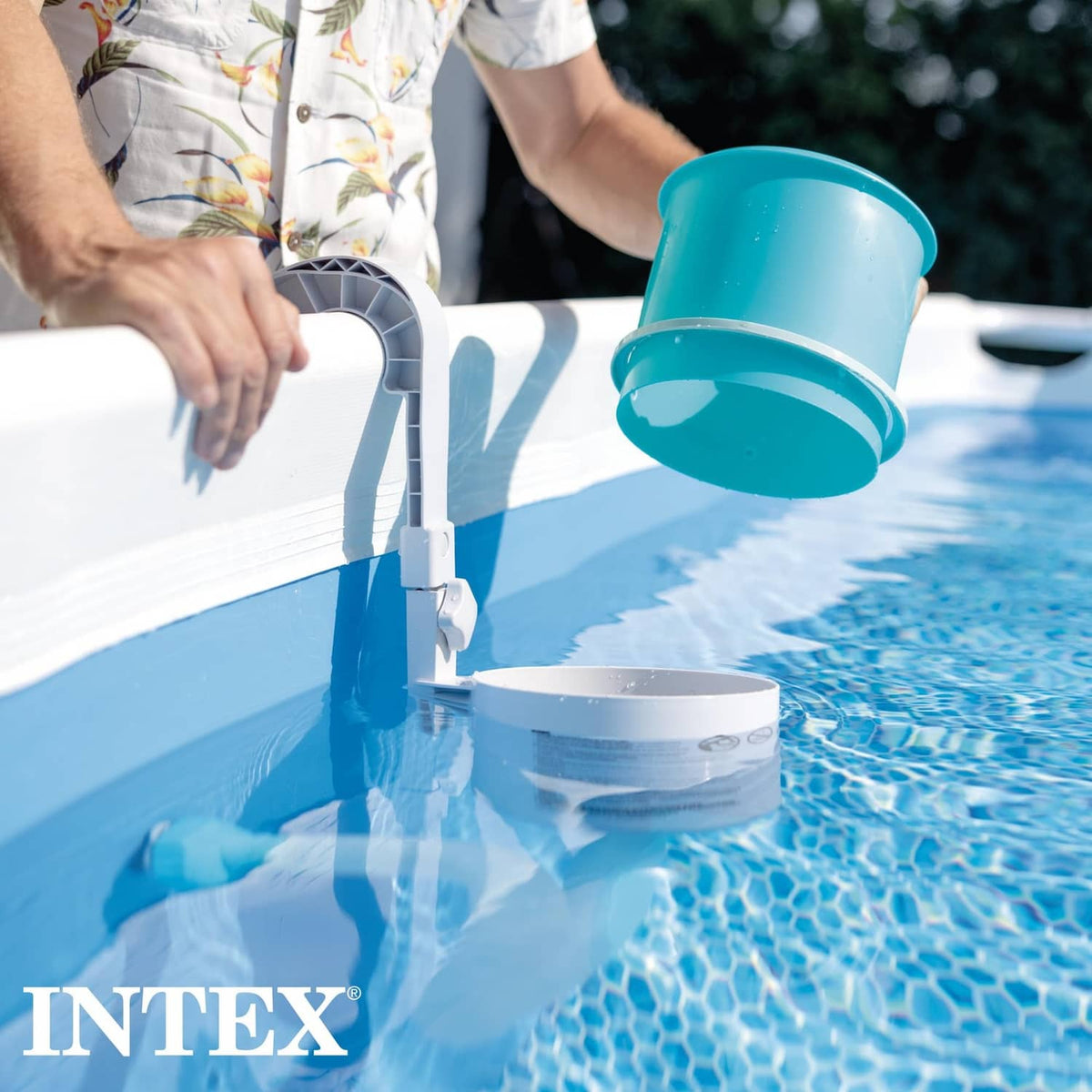 Pool surface skimmer being fitted to the pool wall with blue collection basket