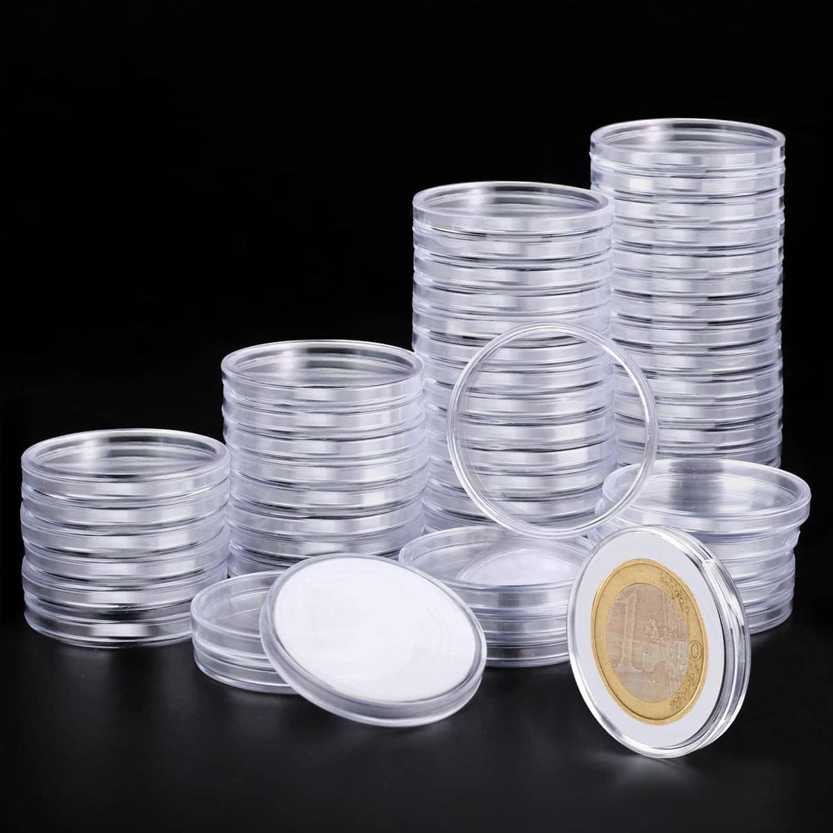 Clear plastic coin capsules set with stacked holders and one open round capsule