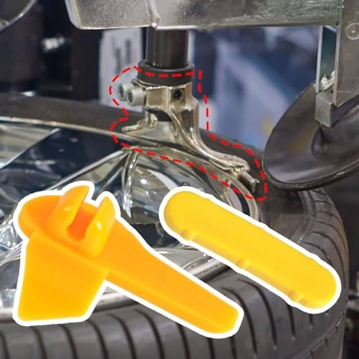 Yellow plastic tire rim protector insert placed on the tire bead area beside the changer head