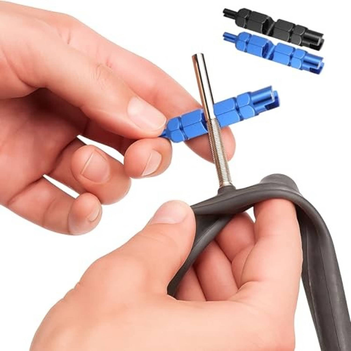 Hands using a blue valve core tool on a tire valve stem