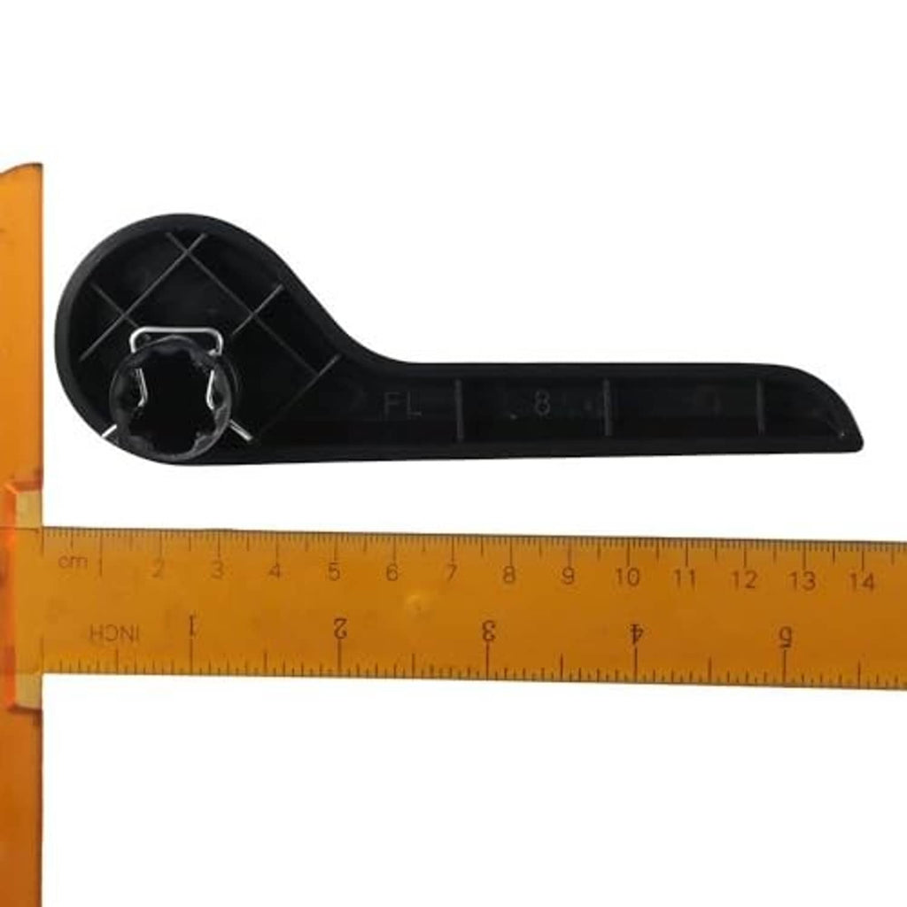 Black recliner handle lever next to ruler, showing pivot end and slots