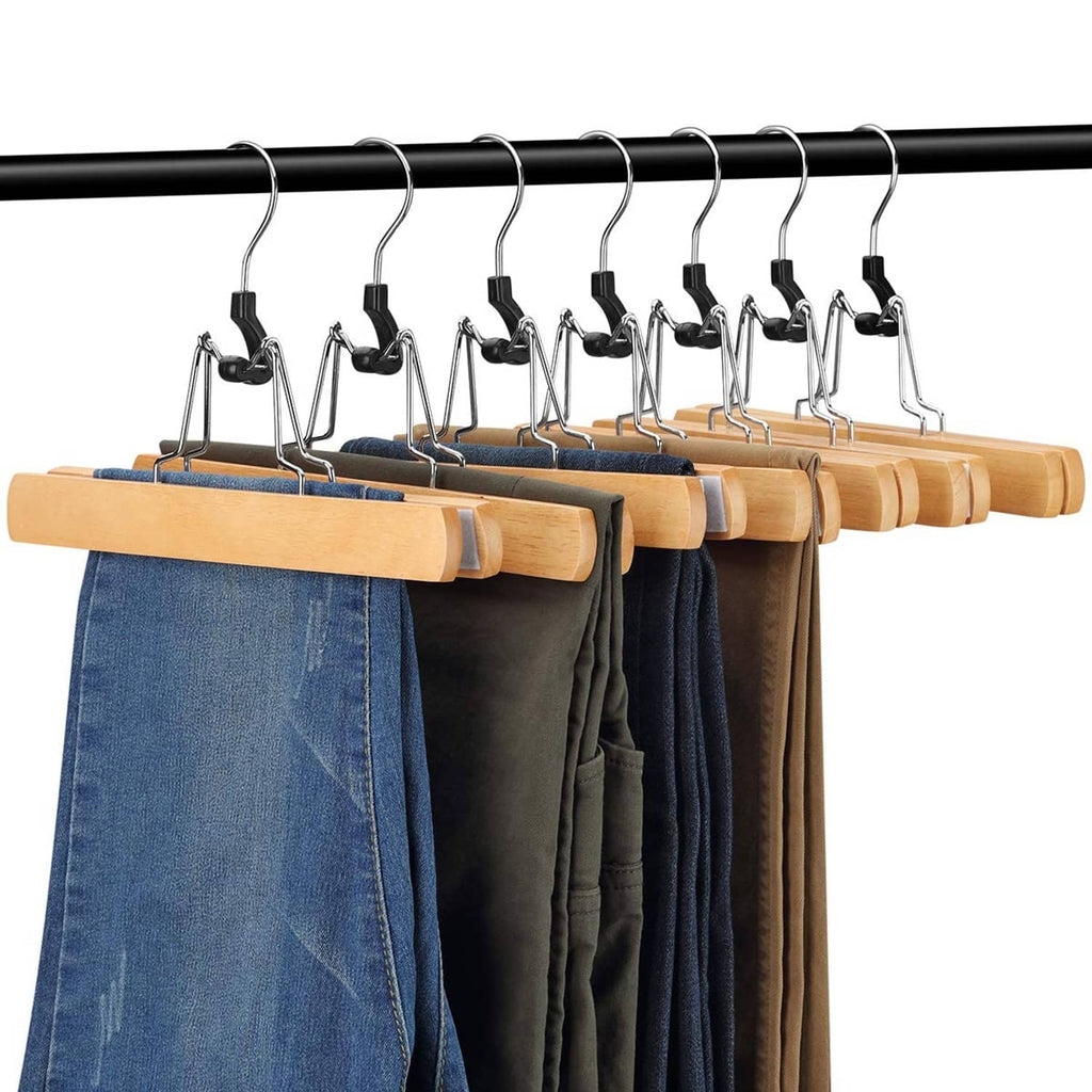 Natural wooden skirt hangers with black clips holding folded clothing on chrome hooks