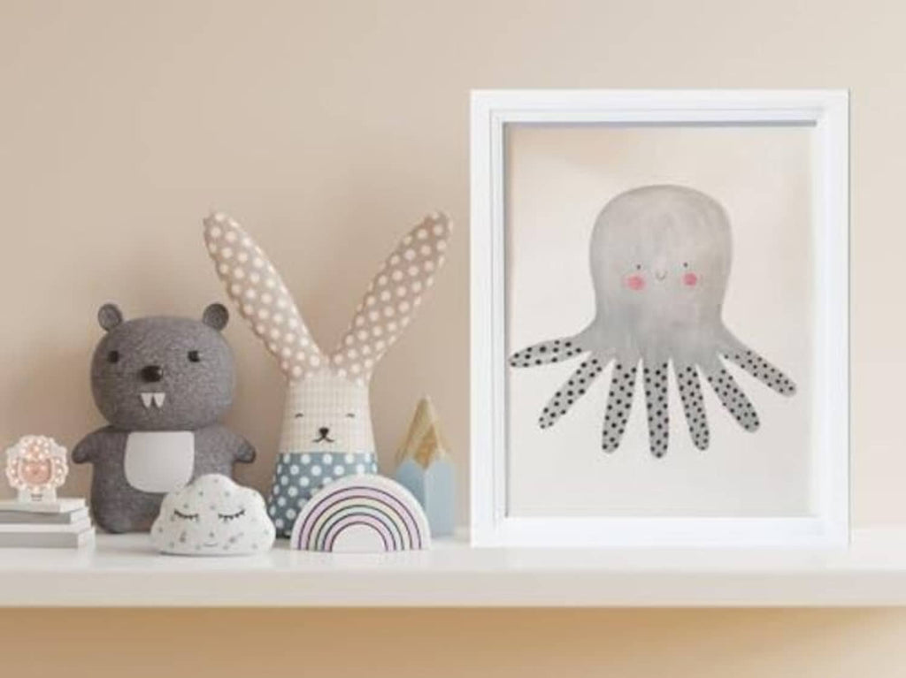 White wooden 8x10 picture frame on a shelf with octopus artwork