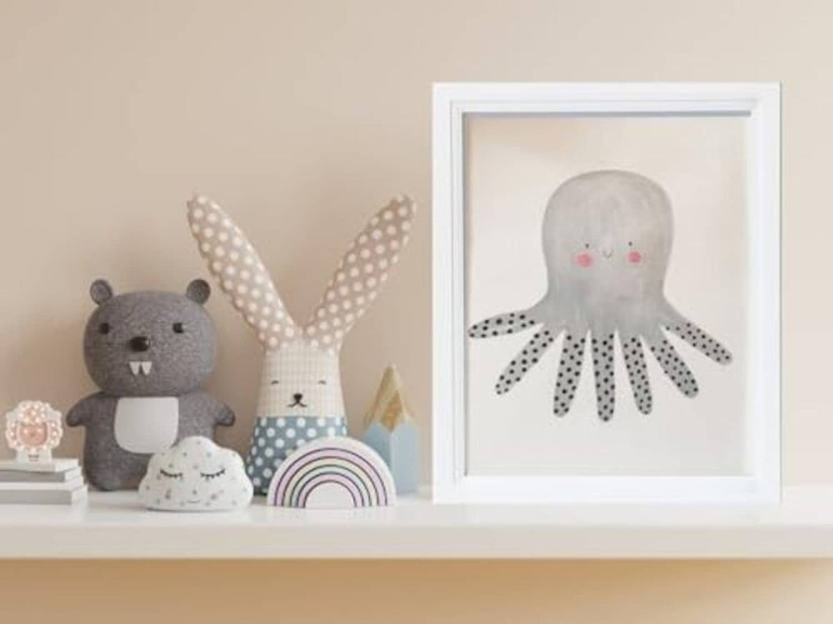 White wooden 8x10 picture frame on a shelf with octopus artwork