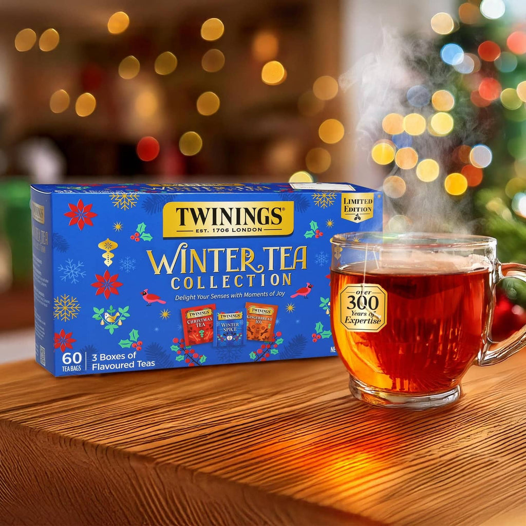 Twinings Winter Tea Collection box with a glass mug of amber tea