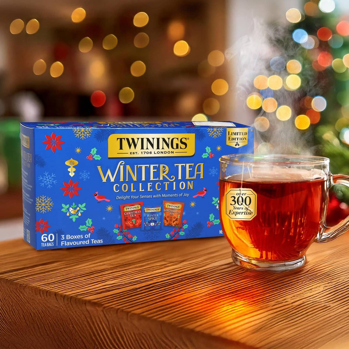 Twinings Winter Tea Collection box with a glass mug of amber tea