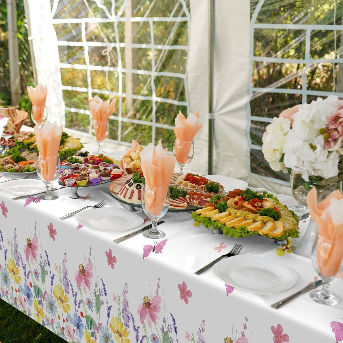 Spring floral tablecloth on outdoor serving table, white with butterfly and flower pattern