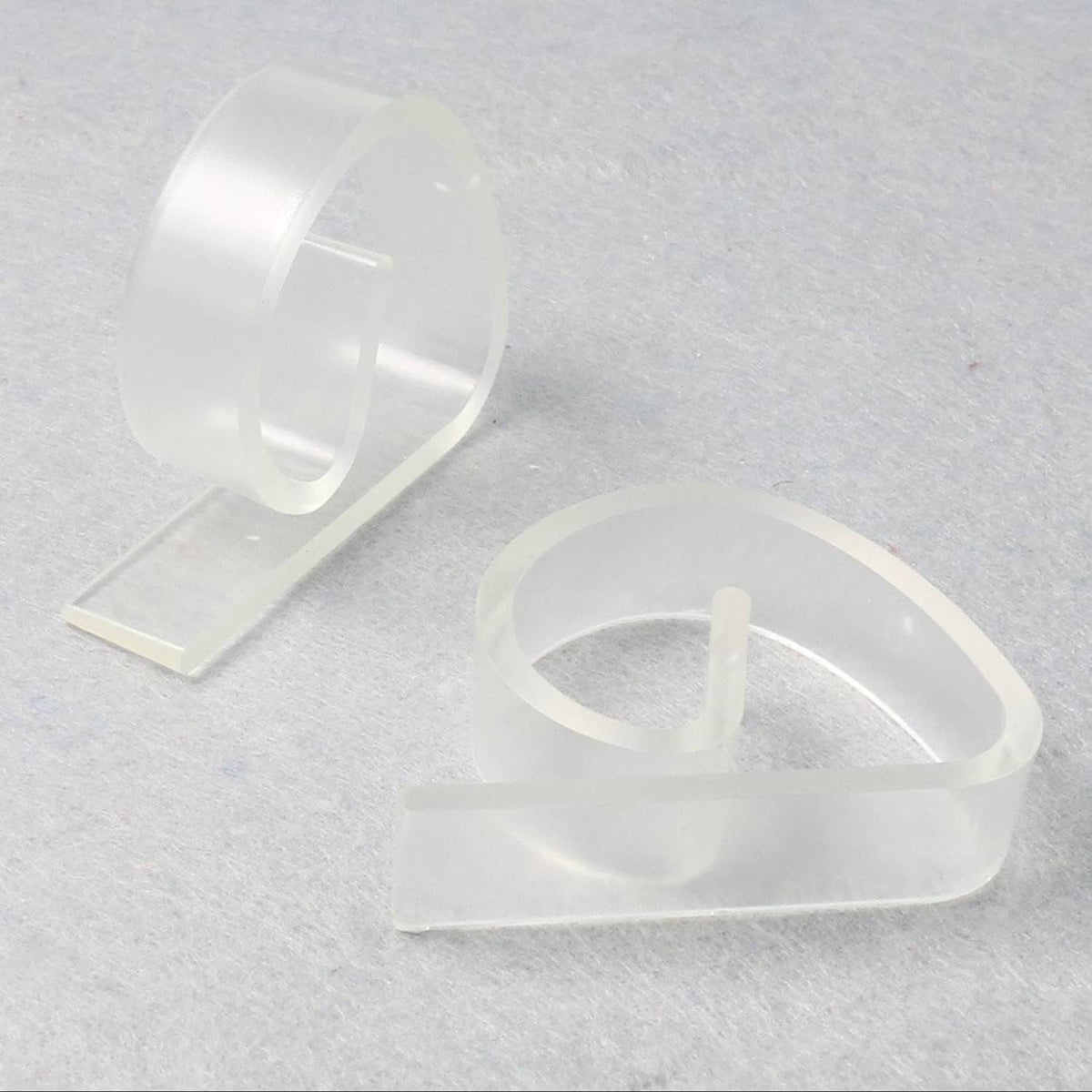 Clear plastic tablecloth clips with open U-shape jaws