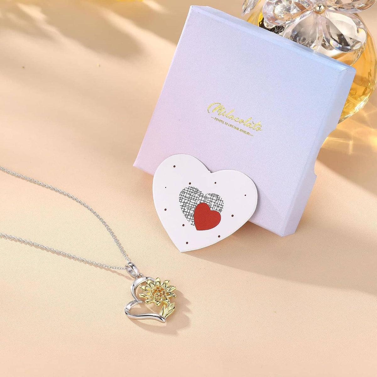 Sunflower heart pendant necklace with silver chain and gold-plated sunflower detail.