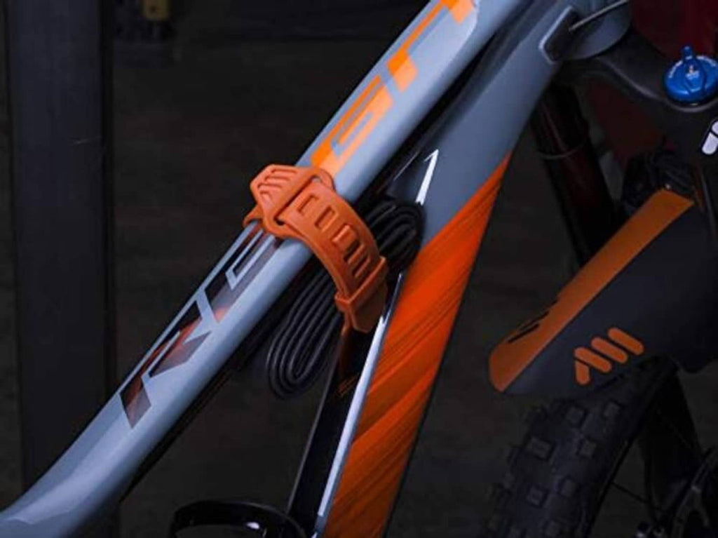 Orange silicone strap securing a bike-mounted camera near the handlebar