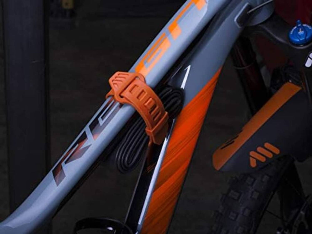 Orange silicone strap securing a bike-mounted camera near the handlebar