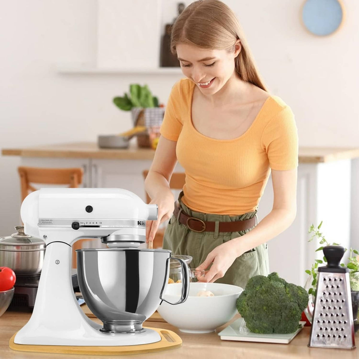 Natural bamboo mixer board with handle placed under stand mixer on kitchen counter
