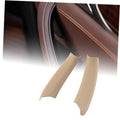 Beige interior door handle pull trim, two curved covers for left and right