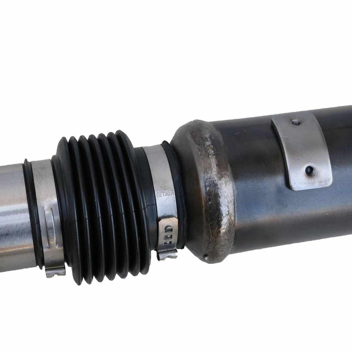 Close-up of front drive shaft boot and metal coupling on black shaft
