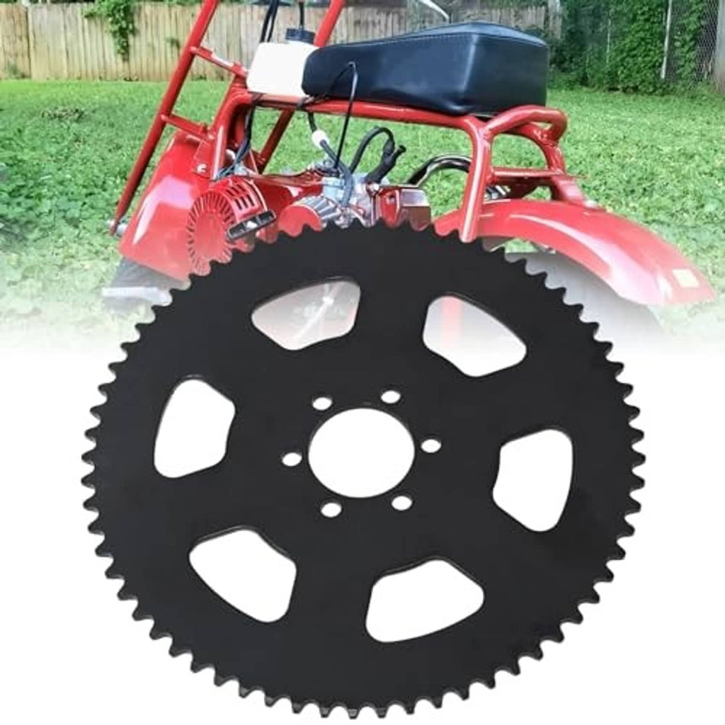 Black rear sprocket gear with oval cutouts on a red mini motorcycle