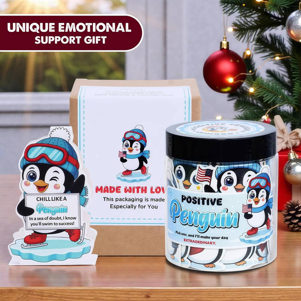 Penguin affirmation card jar with penguin cards and gift box on a wooden table