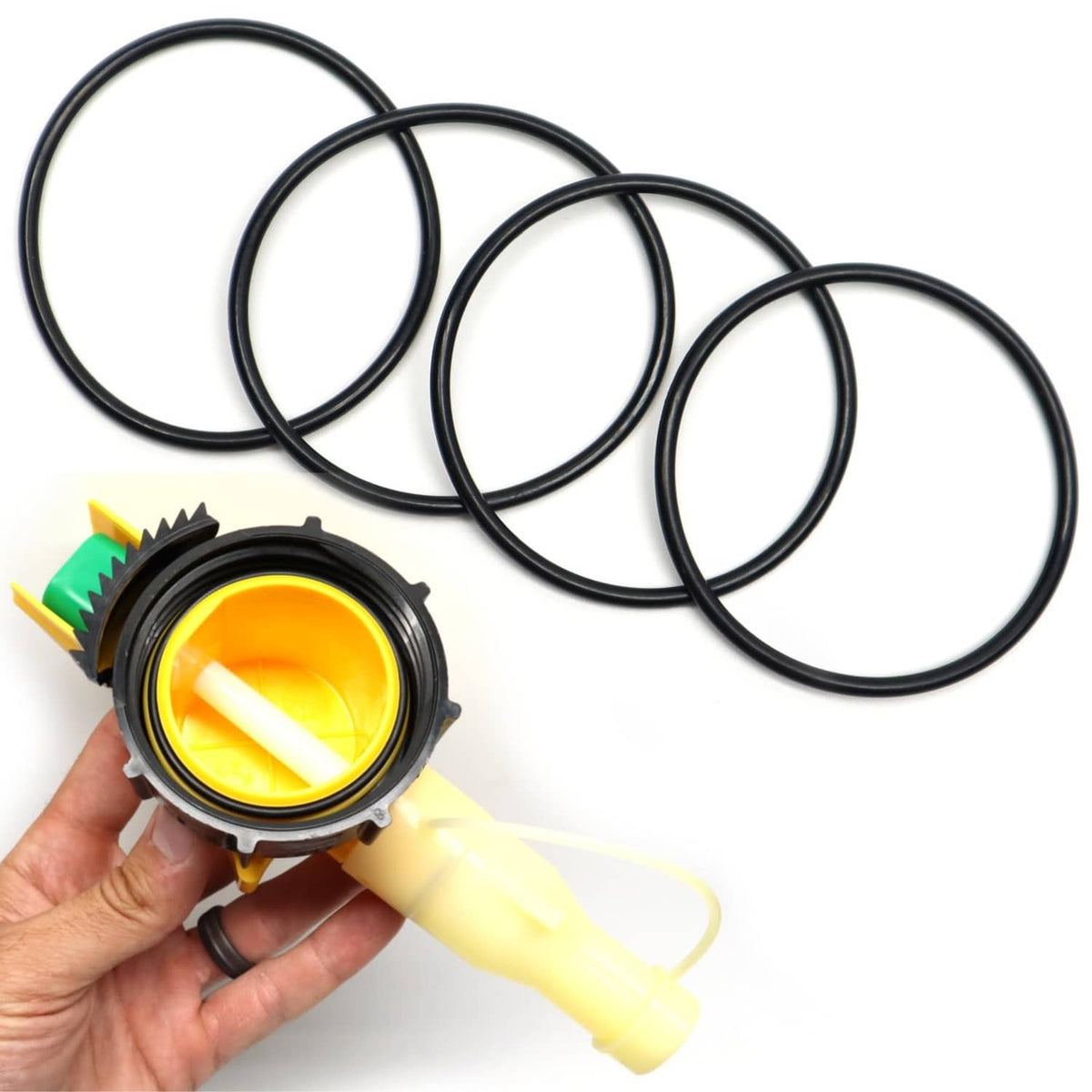 Four black 6235 replacement O-rings and nozzle head, laid out