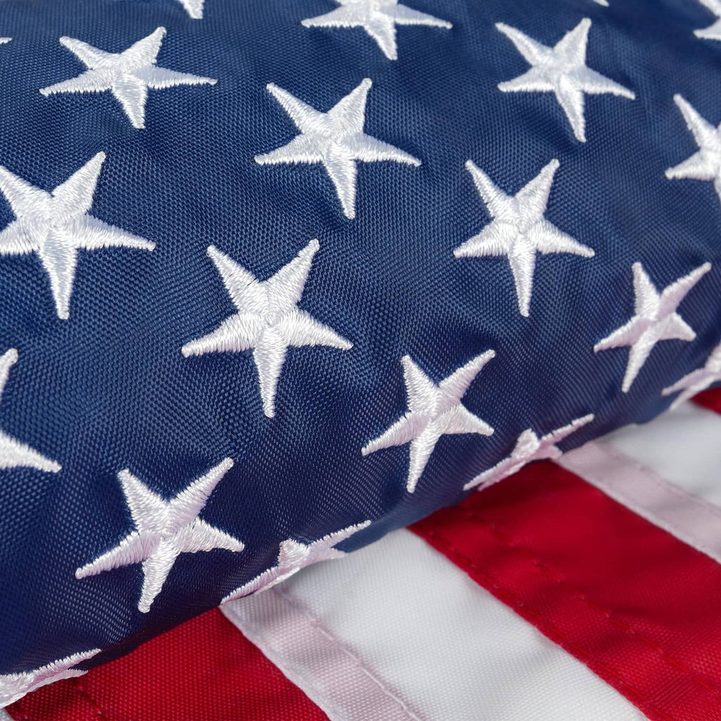 Close-up embroidered American flag fabric with white stars on navy and red-white stripes