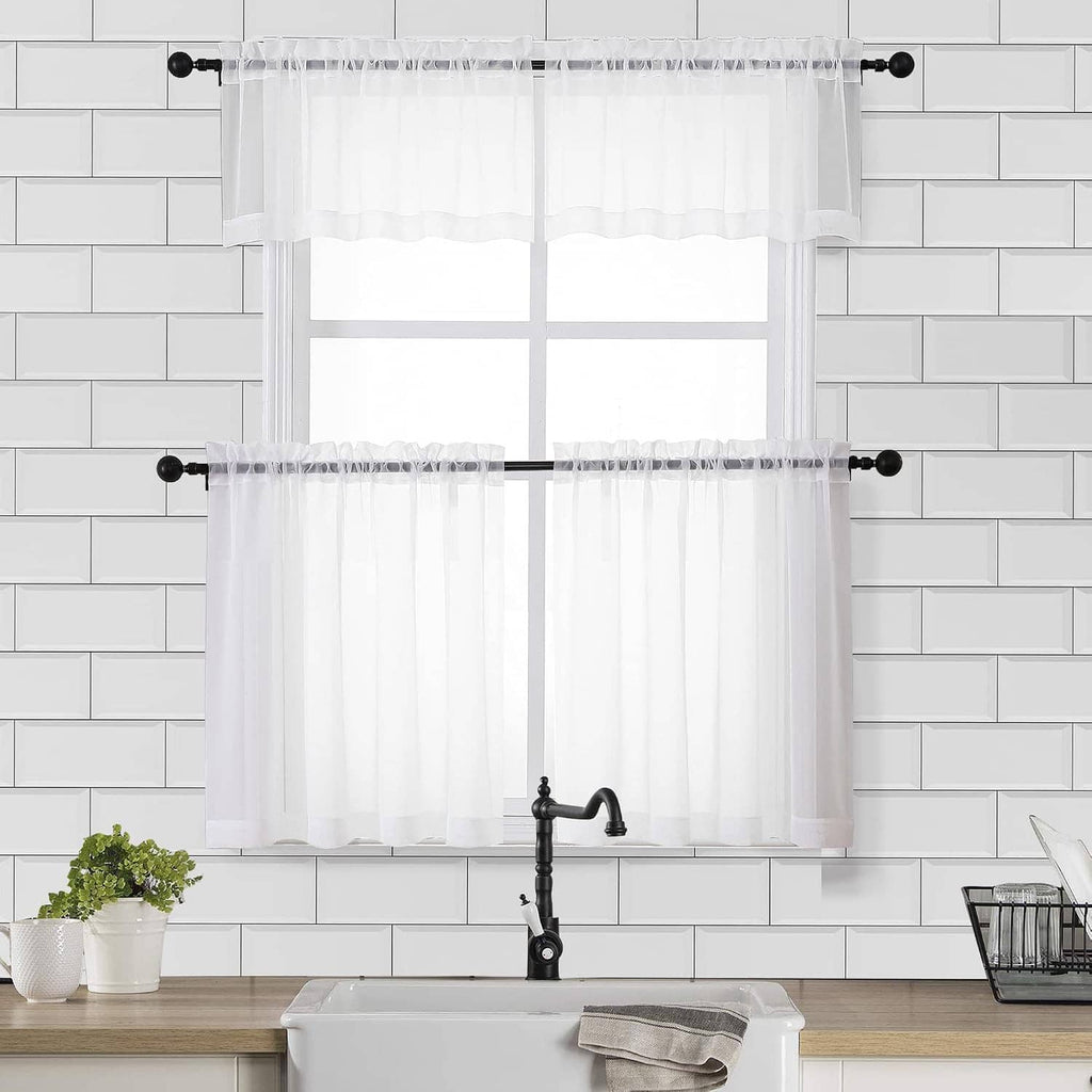 Sheer white window curtain set with ruffled top, hanging on a black rod