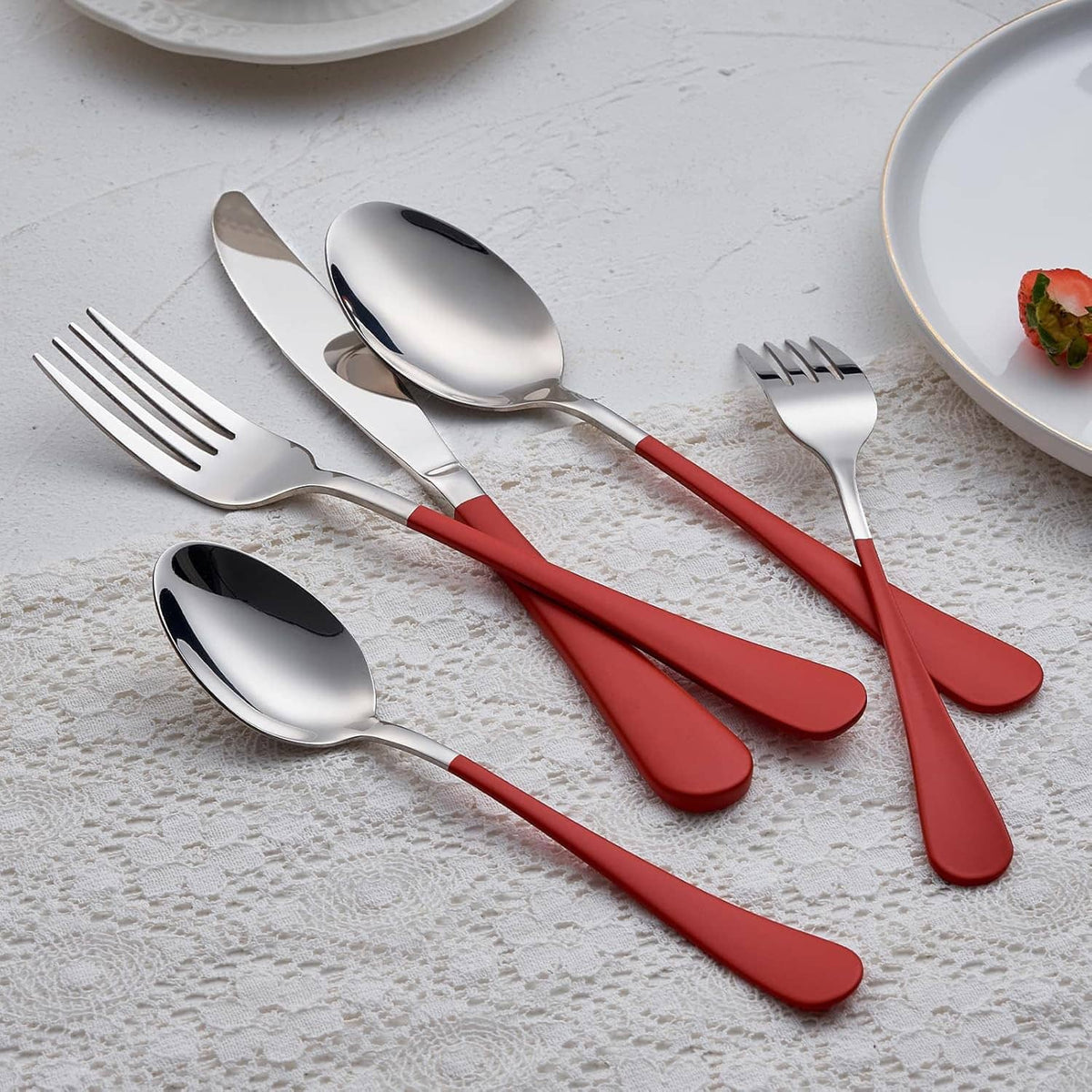 Red-handled stainless utensils set with forks and spoons